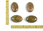 Unakite palm gemstone spa stone, 45x35mm, with green and pink natural mineral patterns, used for relaxation and healing.