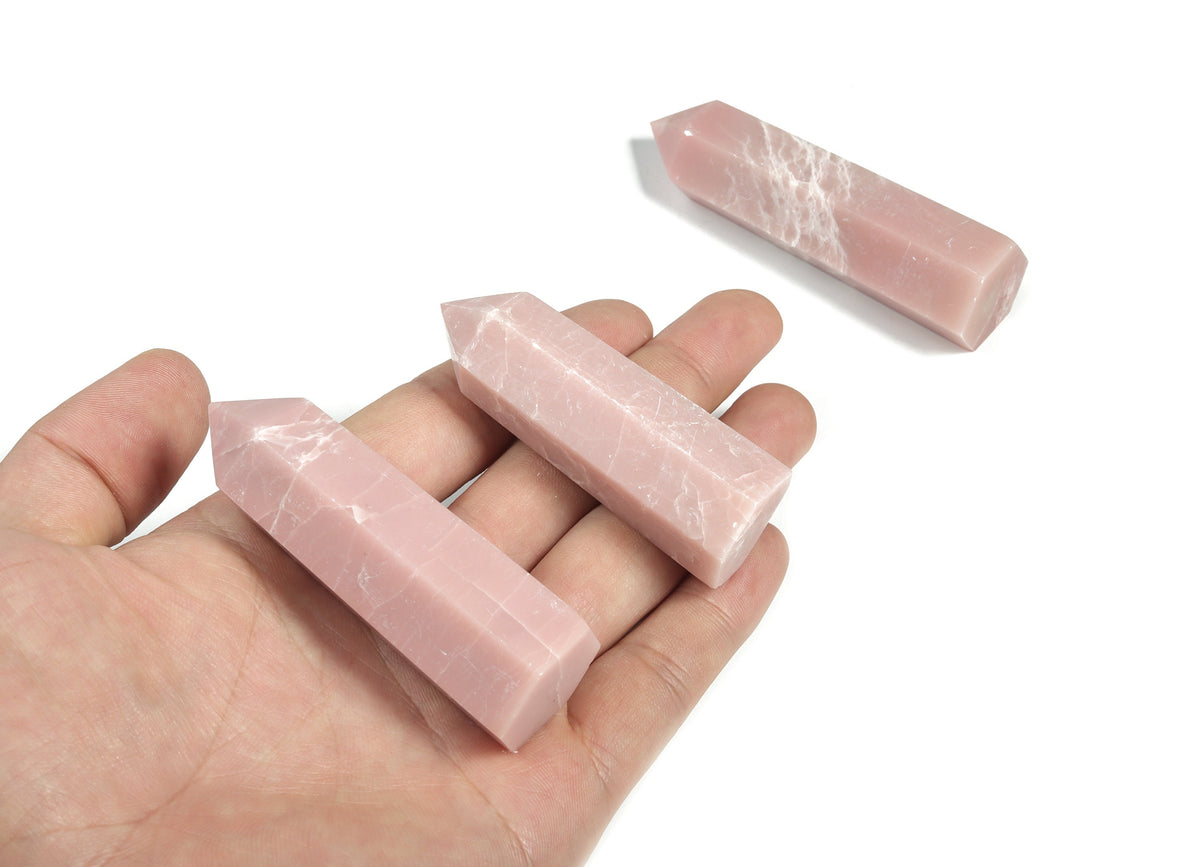 Pink Opal Obelisk Tower crystal from GemstoneGO, featuring a smooth pink gemstone obelisk with natural stone textures.