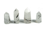 Tourmalinated Quartz obelisk tower crystal from GemstoneGO, featuring black tourmaline inclusions in clear quartz.