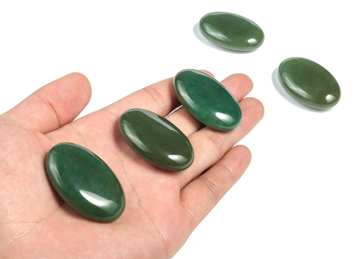 Aventurine palm gemstone spa stone, 45x35mm, showcasing green and shimmering mineral details, used for relaxation and massage.