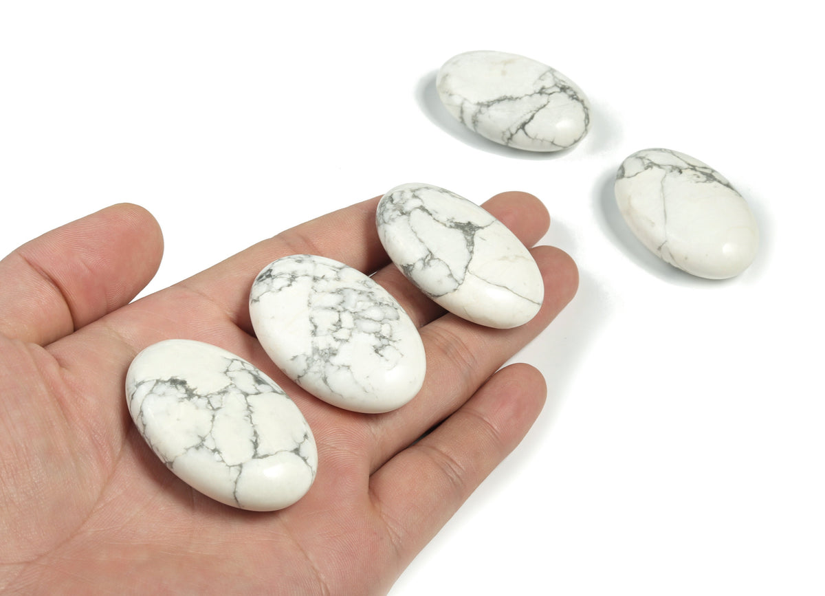 Howlite palm gemstone spa stone, 45x35mm, from GemstoneGO, showcasing a smooth, polished white and gray patterned healing stone.