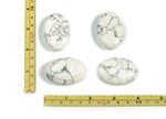 Howlite palm gemstone spa stone, 45x35mm, smooth white and grey mineral healing stone for relaxation and massage.