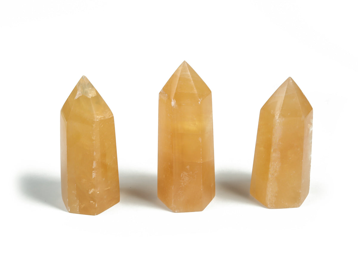 Orange Calcite obelisk tower crystal from GemstoneGO, showcasing vibrant orange color and smooth polished surface.