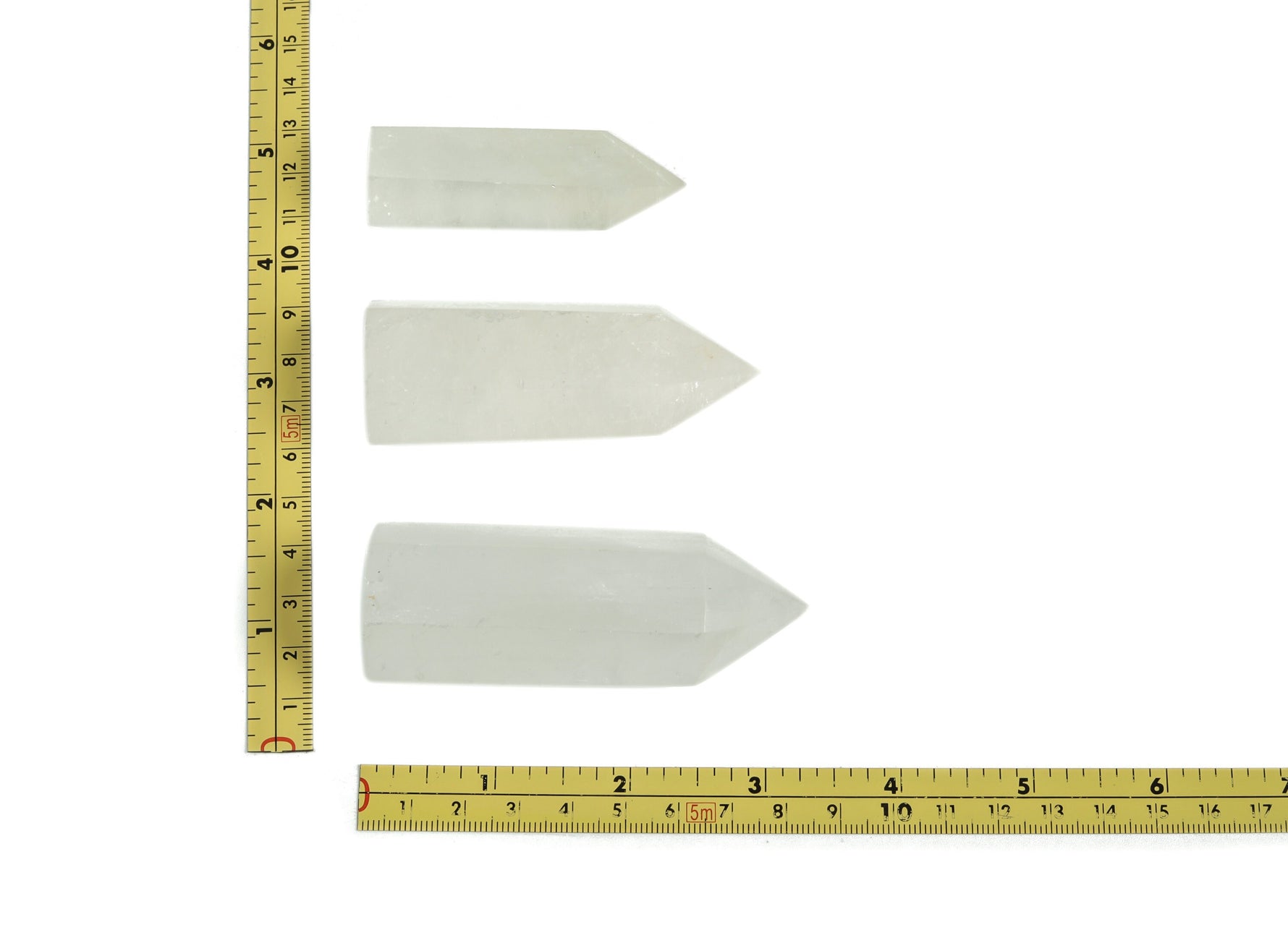 Snow Quartz obelisk tower crystal from GemstoneGO featuring a smooth, polished white gemstone obelisk with natural crystal patterns.