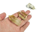 Citrine Obelisk Tower crystal from GemstoneGO with a vibrant orange-yellow hue and pointed geometric shape.