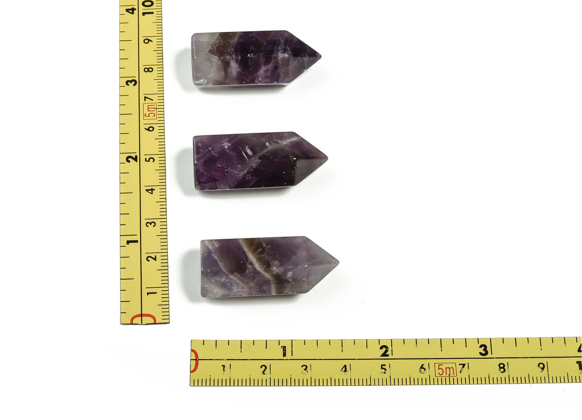 Amethyst obelisk tower crystal from GemstoneGO, 35mm tall, featuring purple gemstone with natural crystal patterns and polished finish.
