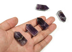 Amethyst obelisk tower crystal from GemstoneGO, 35mm tall, showcasing purple hues and natural crystal formation.