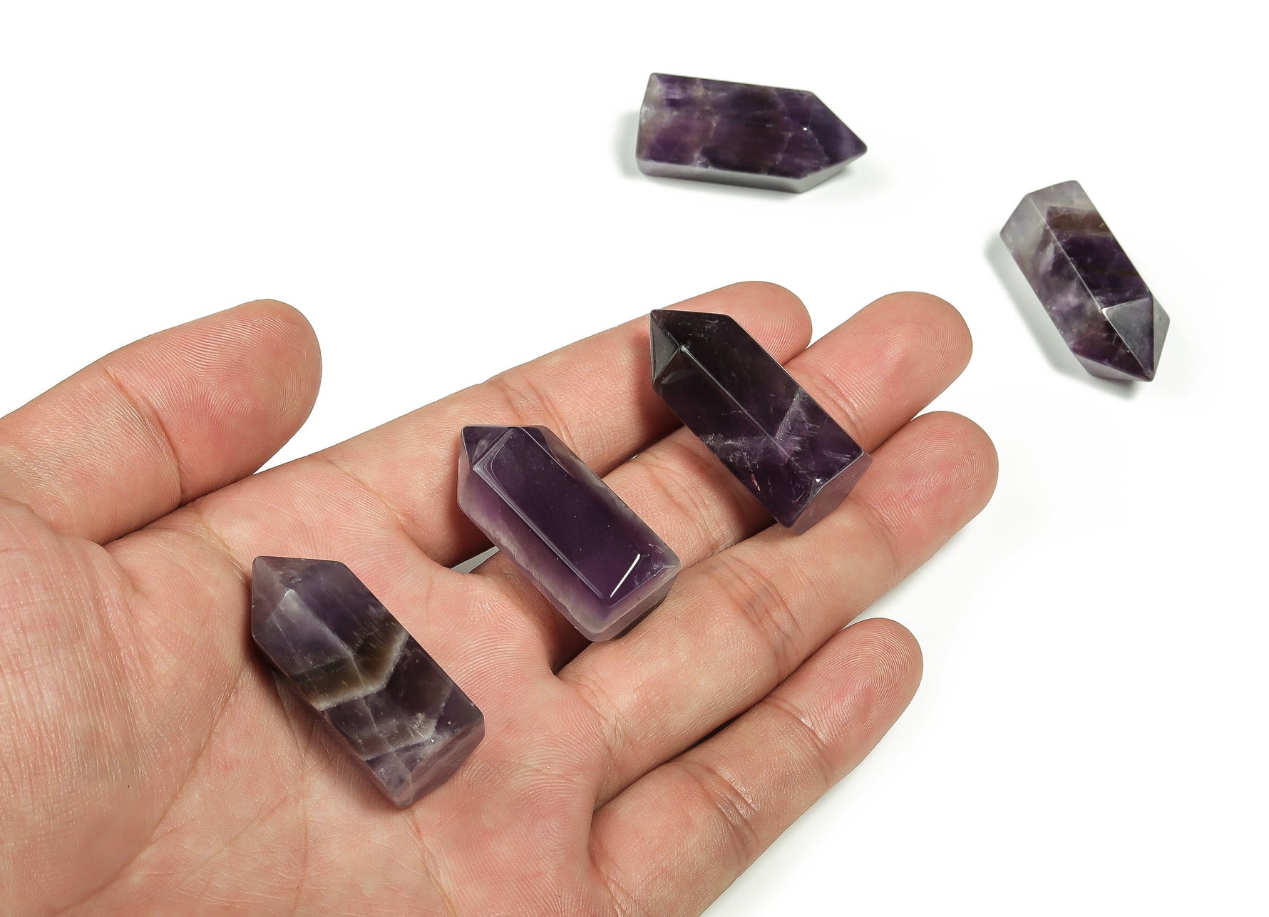 Amethyst obelisk tower crystal from GemstoneGO, 35mm tall, showcasing purple hues and natural crystal formation.