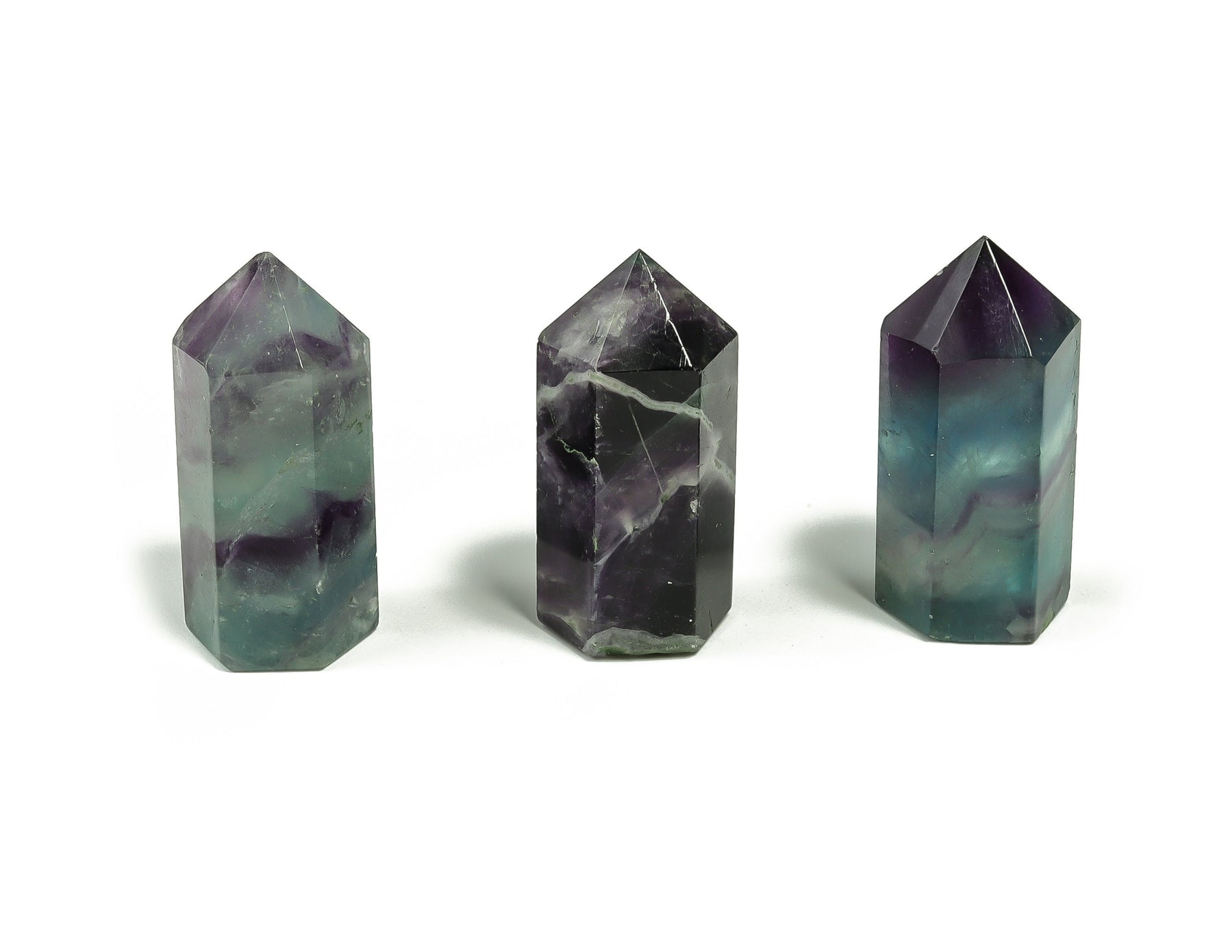 Bright green fluorite obelisk crystal tower, 35mm tall, from GemstoneGO, with natural stone striations and polished surface.