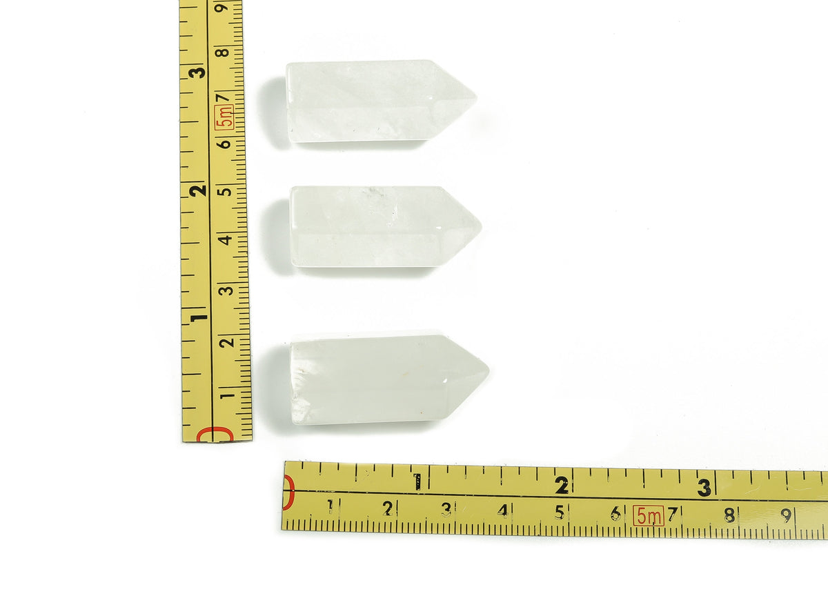 Clear quartz obelisk tower crystal from GemstoneGO, 35mm tall, with a polished, translucent appearance and natural crystal facets.
