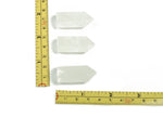 Clear quartz obelisk tower crystal from GemstoneGO, 35mm tall, with a polished, translucent appearance and natural crystal facets.
