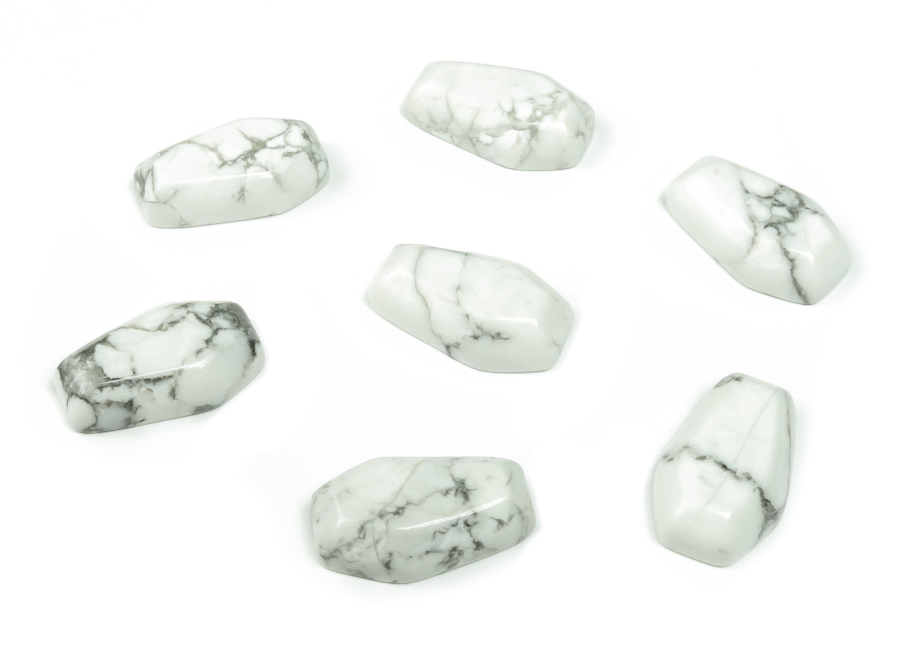Howlite coffin-shaped crystal cabochon from GemstoneGO, 30mm, featuring smooth carved surface and natural white and gray veining.