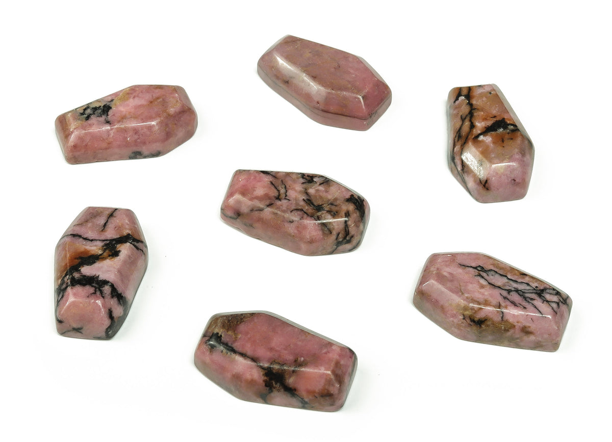 Rhodonite coffin-shaped crystal cabochon carving by GemstoneGO, 30mm, polished gemstone with pink and black patterns.