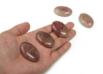 Strawberry Quartz palm gemstone spa stone, 45x35mm, with polished smooth surface and vibrant pink color, ideal for relaxation or healing.