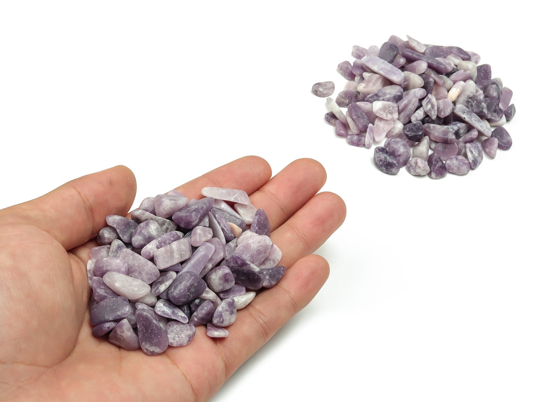 Lepidolite crystal chips, semi-tumbled stones, 7-12mm, shown in bulk from GemstoneGO with purple and lavender hues.