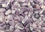 Lepidolite crystal chips in bulk, semi-tumbled 7-12mm gemstones from GemstoneGO showing purple and pink hues in a close-up image.