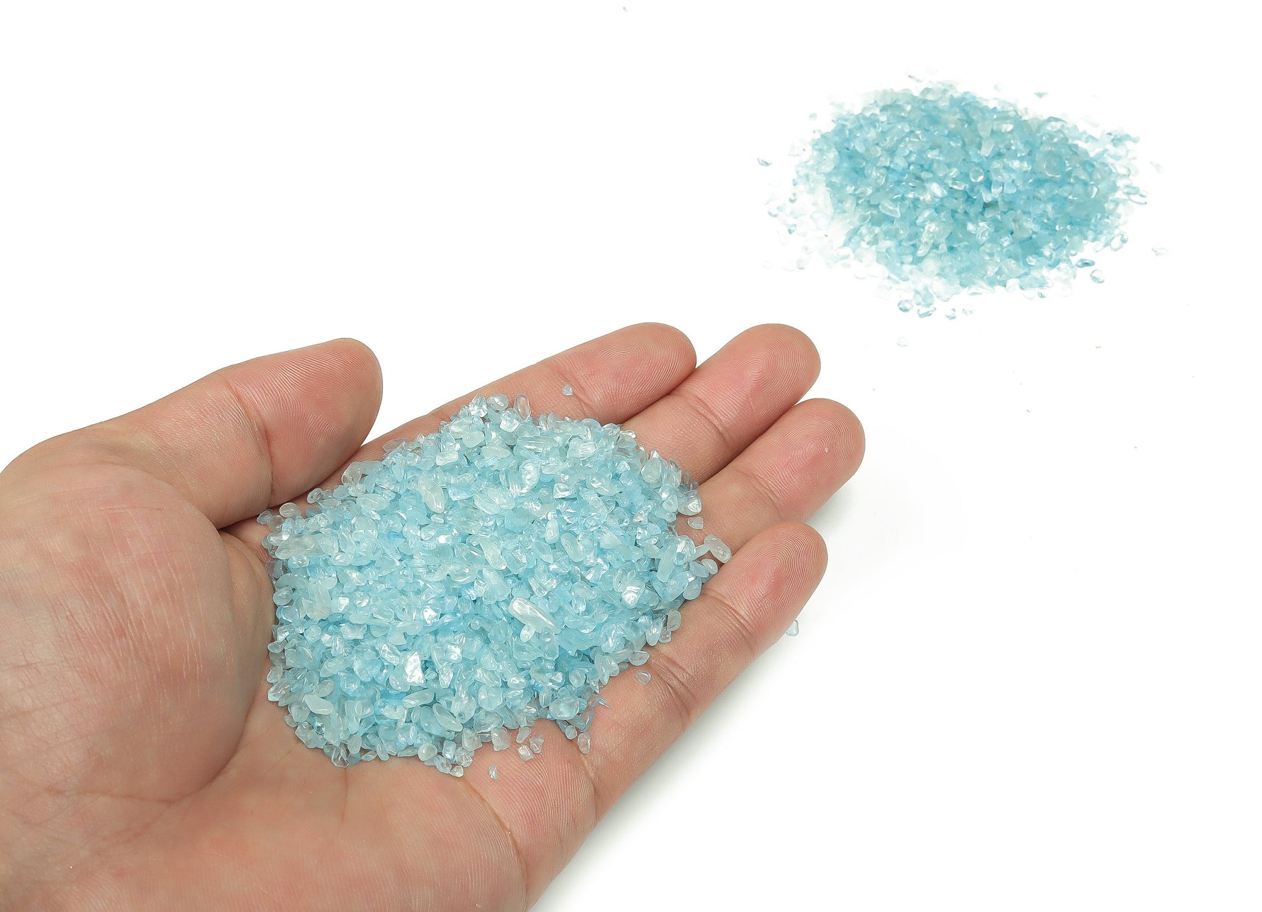 Aquamarine crystal chips in 2-6mm semi-tumbled stones from GemstoneGO, showcasing vibrant blue and green hues for jewelry making.