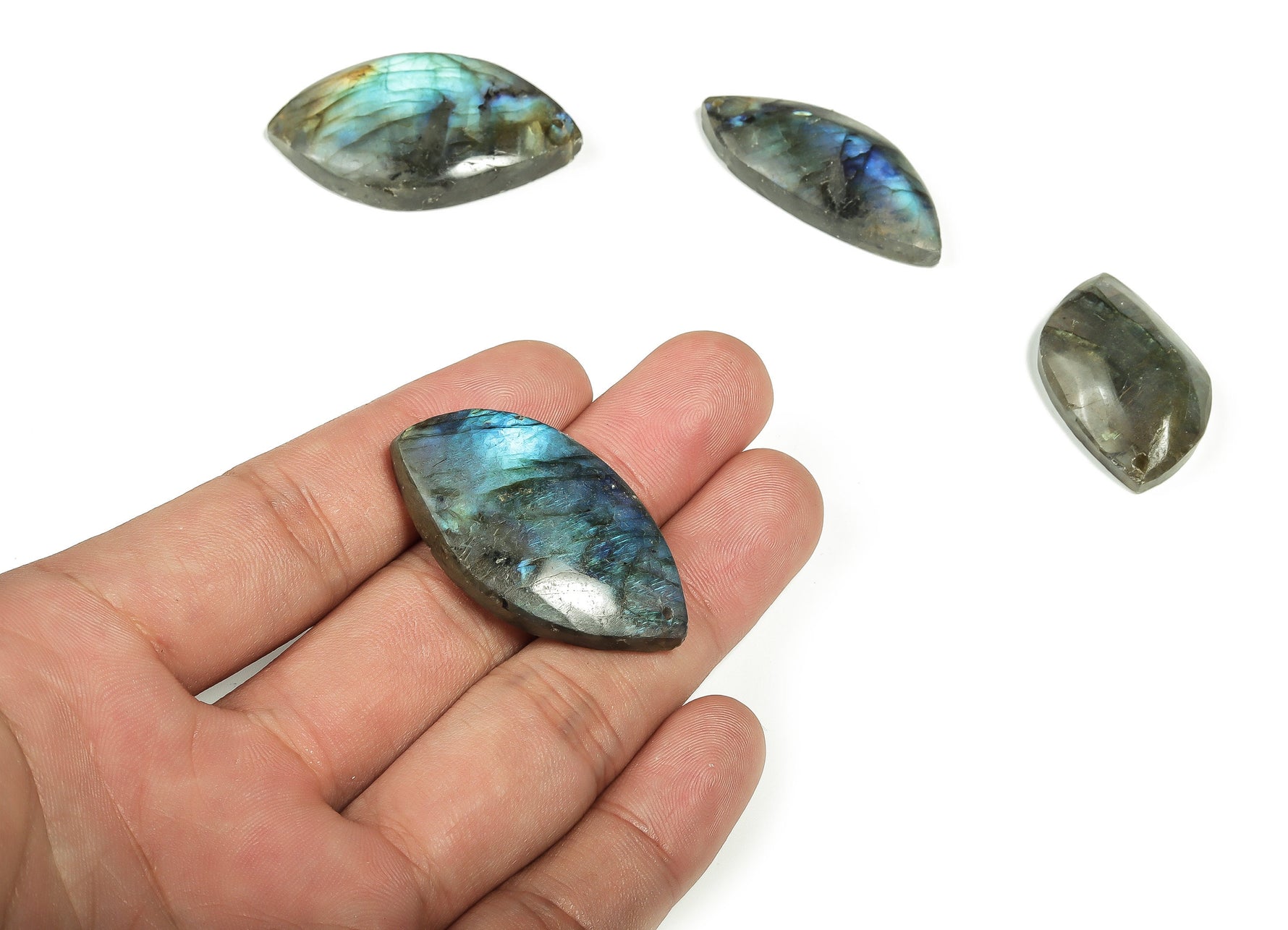 Labradorite leaf-shaped gemstone with hole for jewelry making from GemstoneGO, showcasing iridescent blue and green mineral hues.
