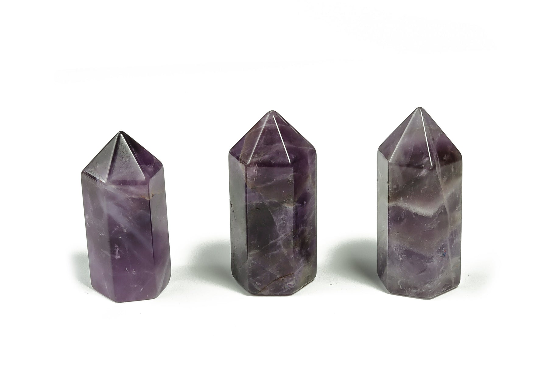 Amethyst obelisk tower crystal from GemstoneGO, 35mm polished gemstone with purple hues and natural crystal details.