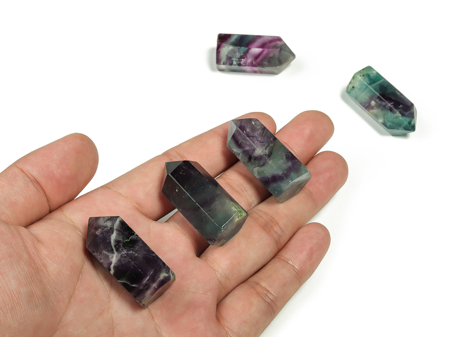 Natural fluorite obelisk tower crystal, 35mm gemstone with vibrant green and purple hues, from GemstoneGO.
