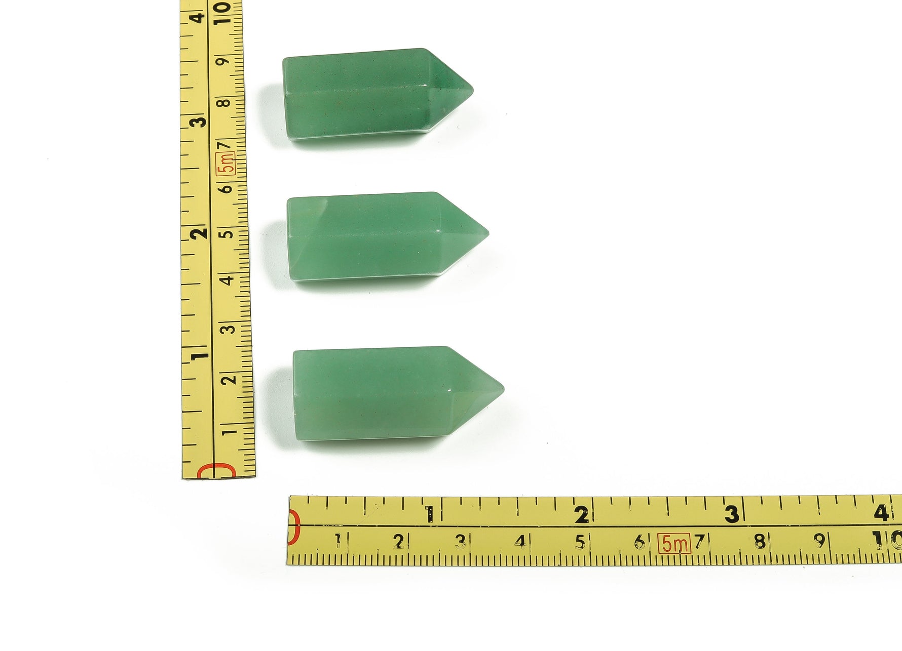 Aventurine obelisk tower crystal from GemstoneGO, 35mm tall, with green and shimmering mineral patterns on a white background.