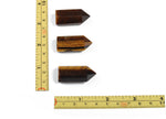 Tiger Eye obelisk tower crystal, 35mm gemstone from GemstoneGO, showcasing the polished, golden-brown mineral with natural banding.