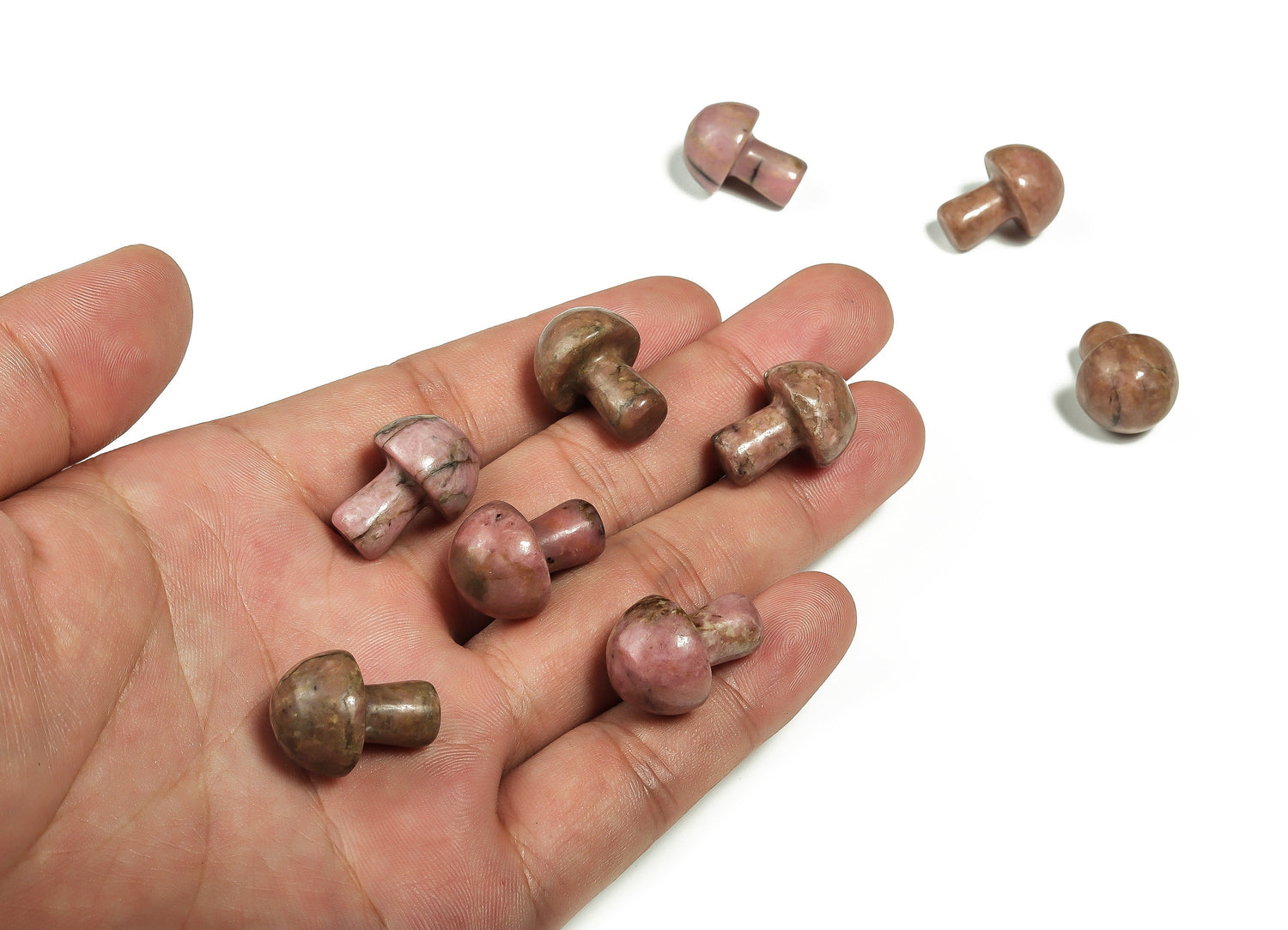 20mm Rhodonite mushroom carved gemstone from GemstoneGO, showing a smooth, polished pink and black stone with mushroom shape and detailed carving.