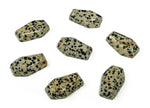Dalmatian Jasper coffin-shaped crystal carving, 30mm cabochon from GemstoneGO, showcasing black spots on creamy stone.