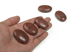 Red Sesame Jasper palm gemstone spa stone, 45x35mm, showcasing smooth, polished red and black patterned jasper for relaxation and healing.
