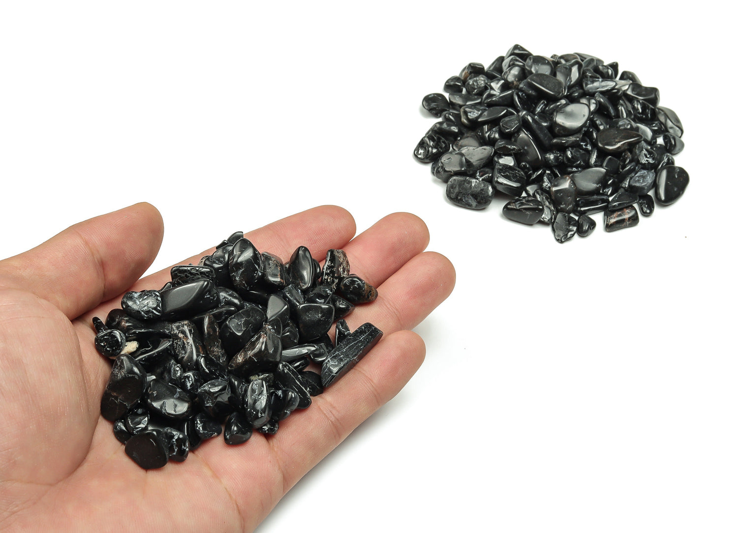 Black Tourmaline crystal chips from GemstoneGO, semi-tumbled 7-12mm bulk stones, shown in close-up with natural black color and shiny surface.