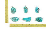 Silver-edged turquoise crystal pendant featuring vibrant turquoise gemstones, showcasing intricate jewelry craftsmanship.