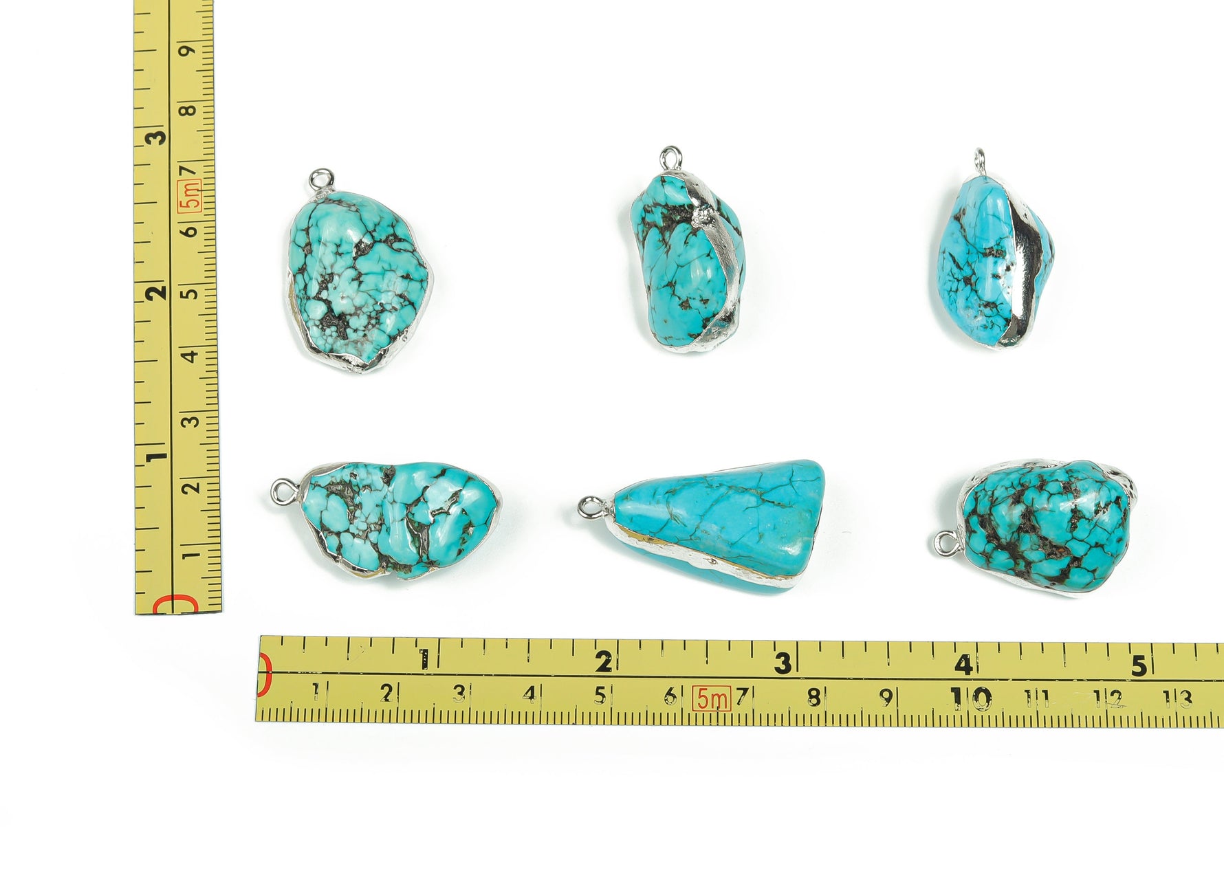 Silver-edged turquoise crystal pendant featuring vibrant turquoise gemstones, showcasing intricate jewelry craftsmanship.