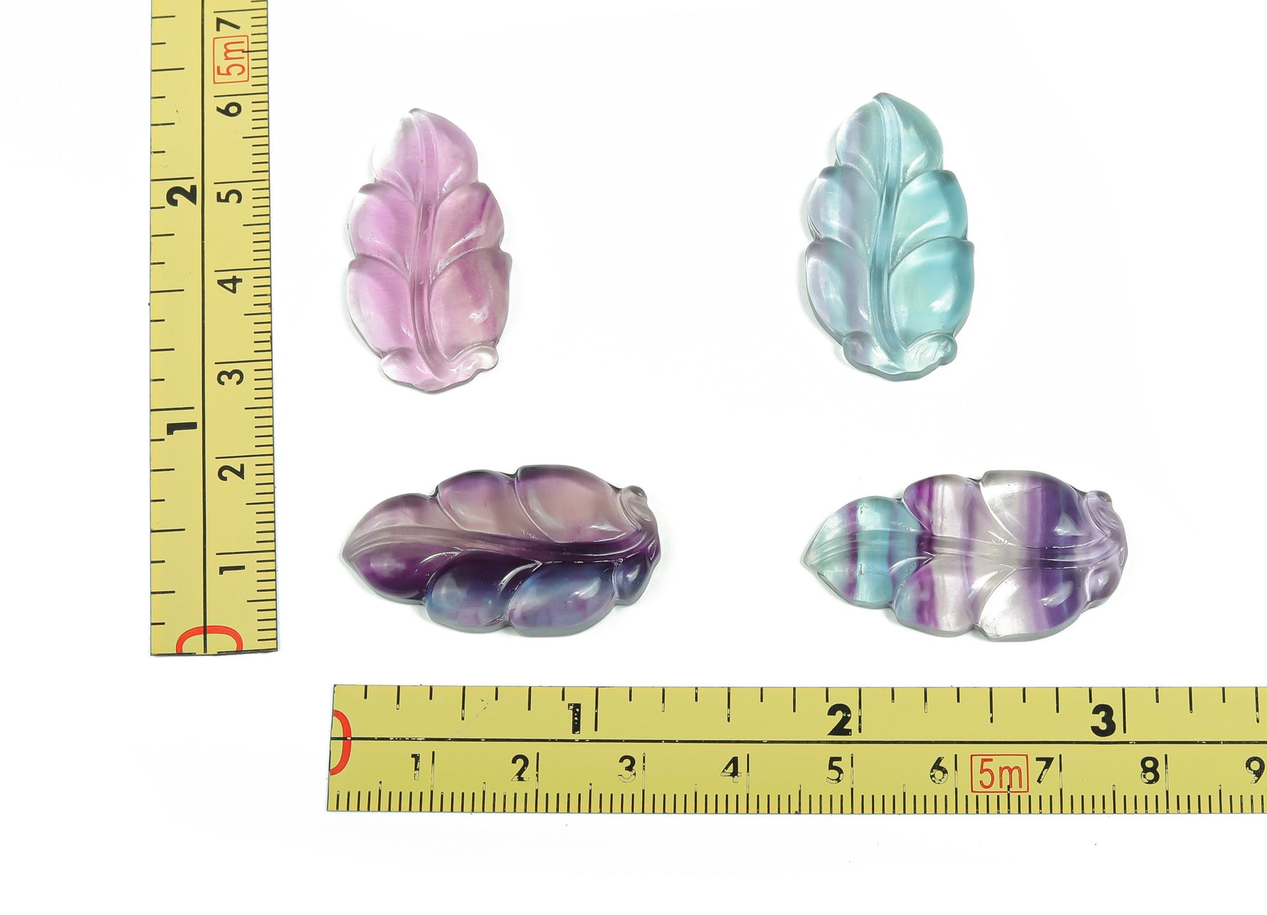 Fluorite leaf carving gemstone from GemstoneGO, showcasing vibrant green and purple hues with detailed leaf design.