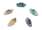 Fluorite wing heart gemstone carving by GemstoneGO showing vibrant green and purple hues with detailed wing and heart shapes.