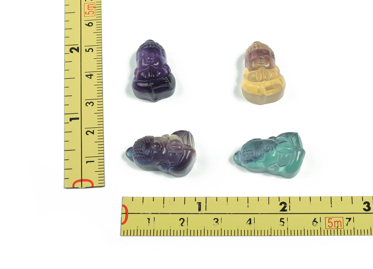 Fluorite Buddha carving gemstone from GemstoneGO, showcasing vibrant purple and green mineral hues and intricate Buddha figure details.