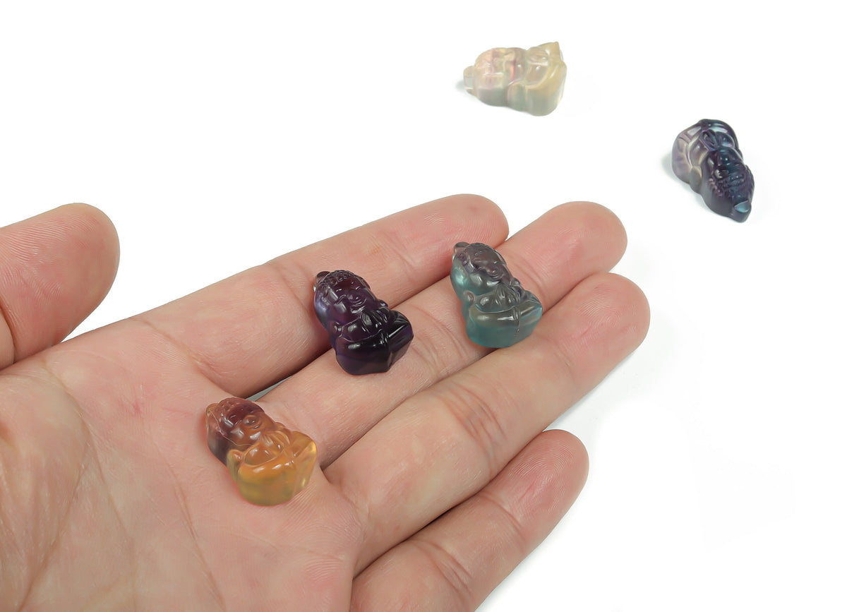 Fluorite Buddha carving gemstone from GemstoneGO showcasing a detailed, colorful Buddha figure carved from vibrant fluorite.