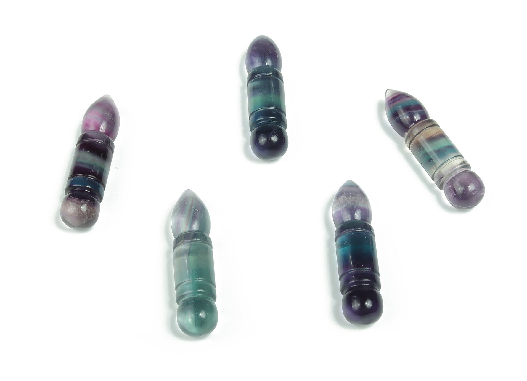 Fluorite bullet-shaped gemstone carving from GemstoneGO, vibrant purple and green hues, polished smooth for display or collection.