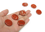 Red Jasper flat gemstone slab, 30x25x7mm, from GemstoneGO, showing a smooth, polished red jasper crystal with natural patterns.