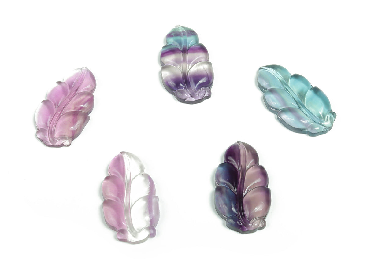 Fluorite leaf carving gemstone by GemstoneGO, detailed green and purple fluorite with intricate leaf design.