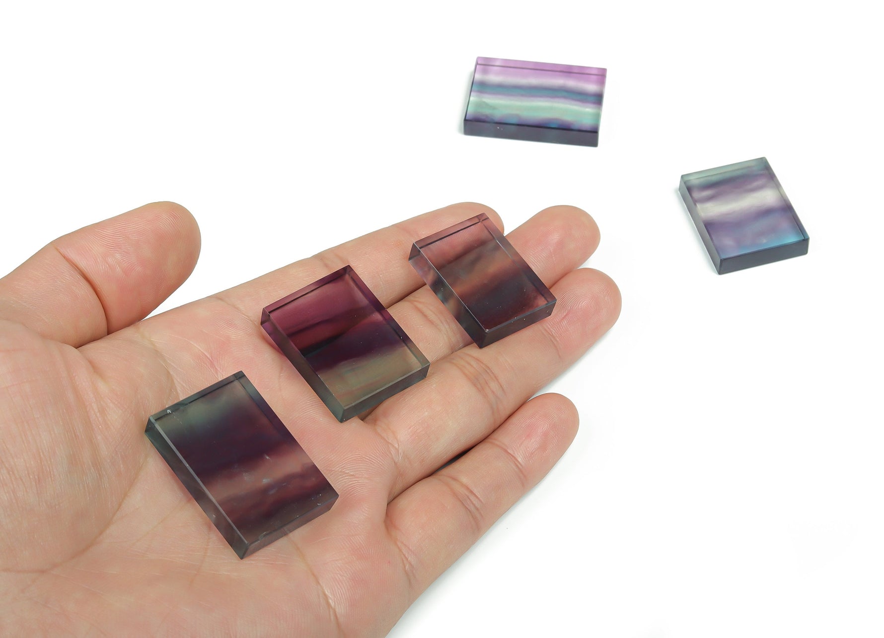 Fluorite slice slab gemstone by GemstoneGO showing vibrant purple and green layers with polished edges and natural crystal patterns.