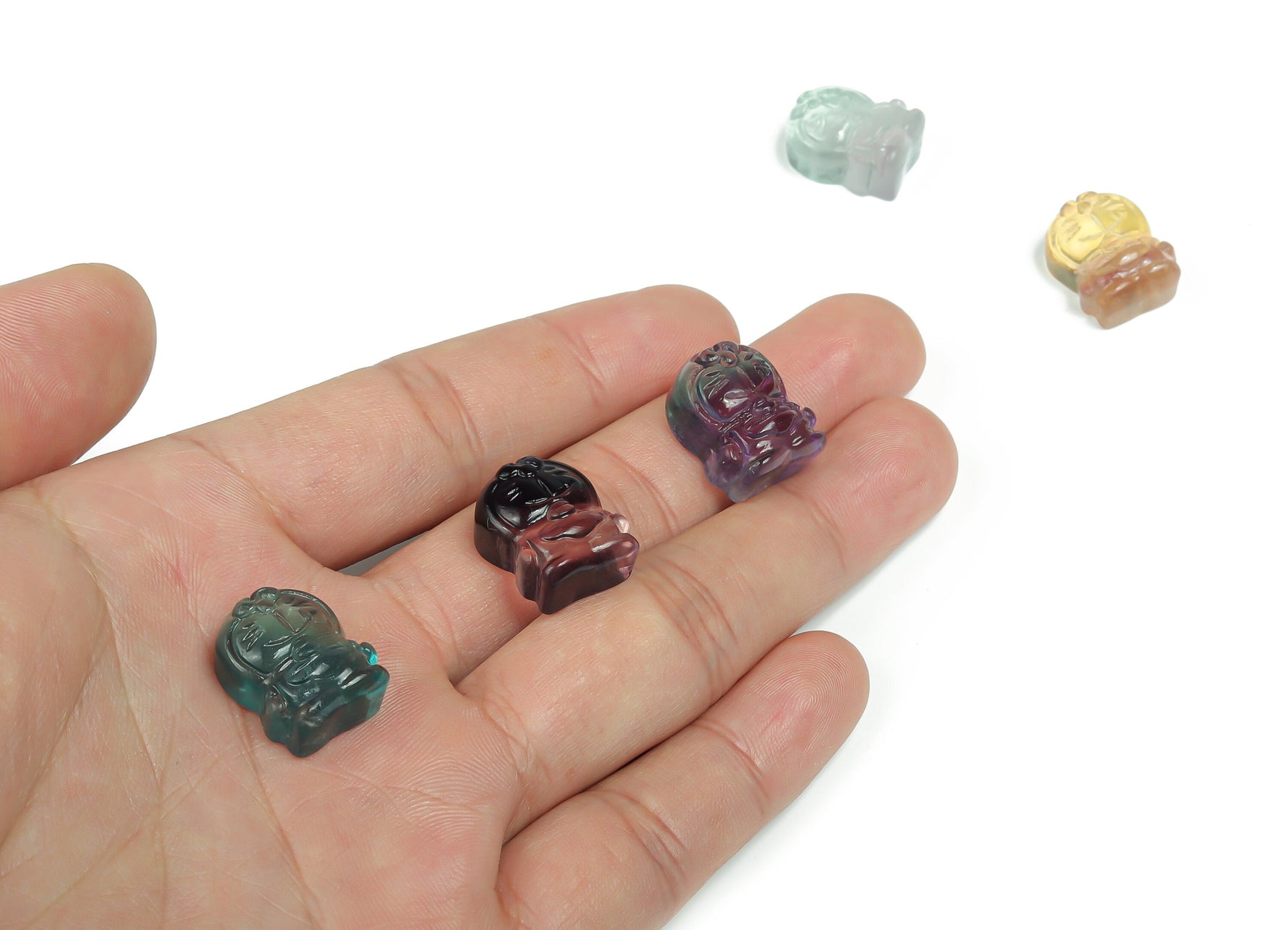 Fluorite cat carving gemstone by GemstoneGO, vibrant purple and green hues, detailed feline sculpture on a smooth surface.