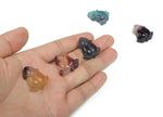 Fluorite rose flower gemstone carving by GemstoneGO, showcasing vibrant purple and green hues with intricate floral details.