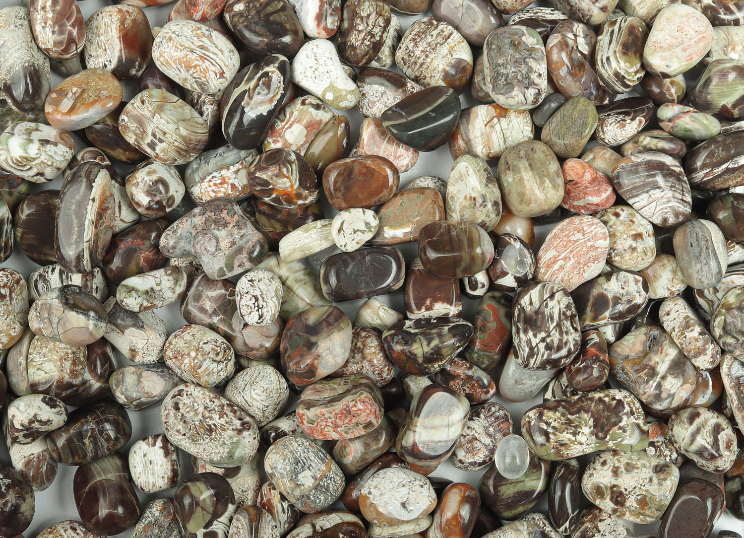 Semi-tumbled Rhyolite crystal chips in rainforest green, 7-12mm, from GemstoneGO, displayed in a natural, bulk collection.