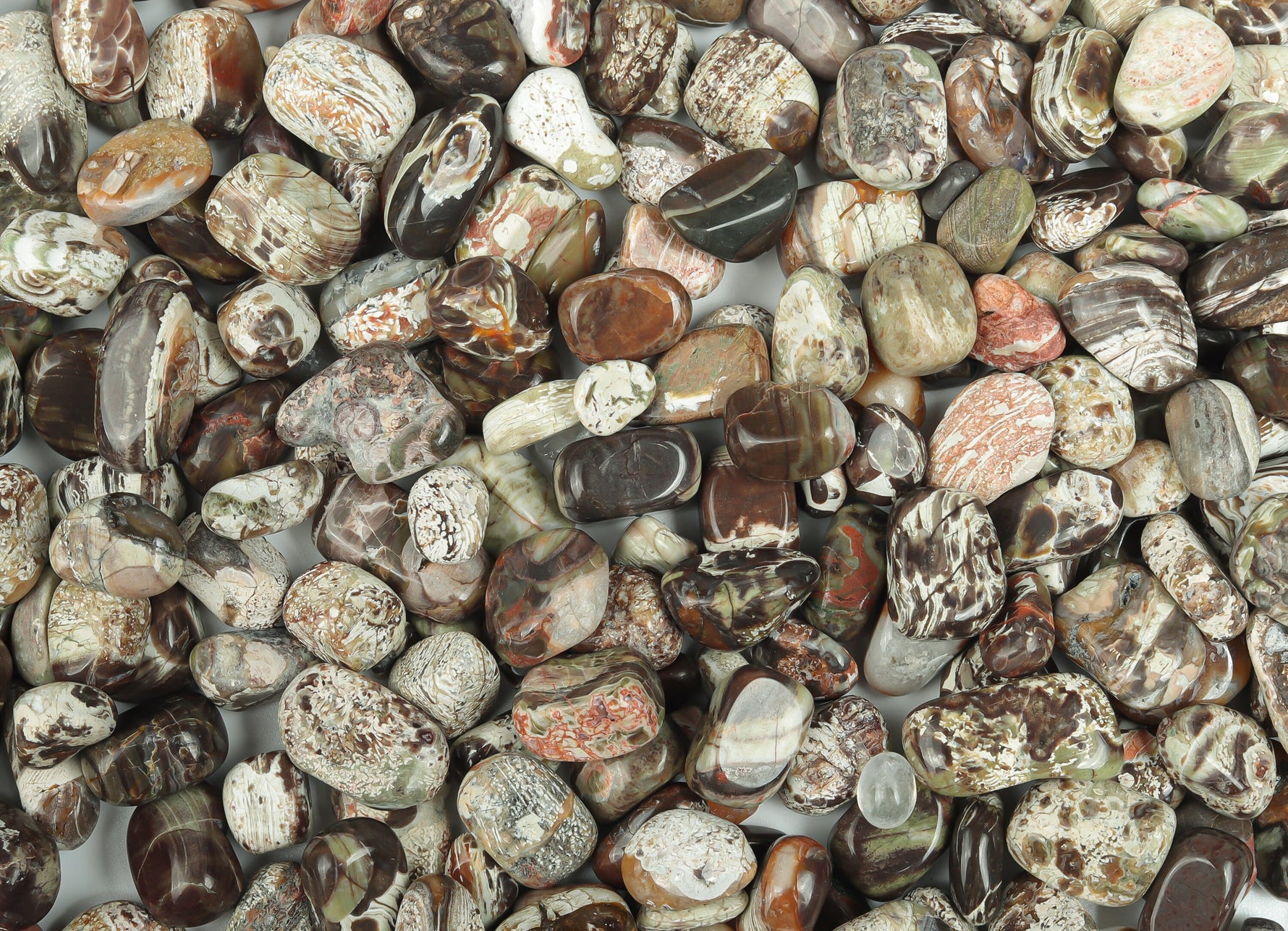 Semi-tumbled Rhyolite crystal chips in rainforest green, 7-12mm, from GemstoneGO, displayed in a natural, bulk collection.