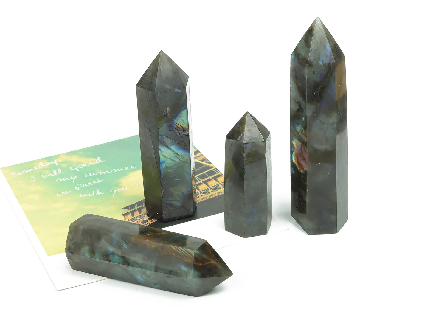 Labradorite obelisk tower crystal from GemstoneGO showing iridescent gray and blue hues with a polished pointed tip.