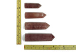 Strawberry Quartz obelisk tower crystal by GemstoneGO, featuring a polished pink gemstone with natural striations and smooth surfaces.