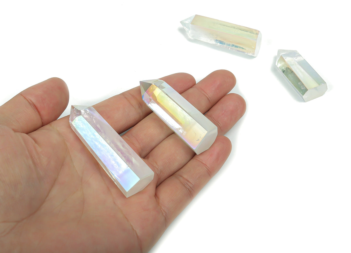 Angel Aura Quartz obelisk crystal tower from GemstoneGO, featuring a shimmering, iridescent finish and pointed tower shape.