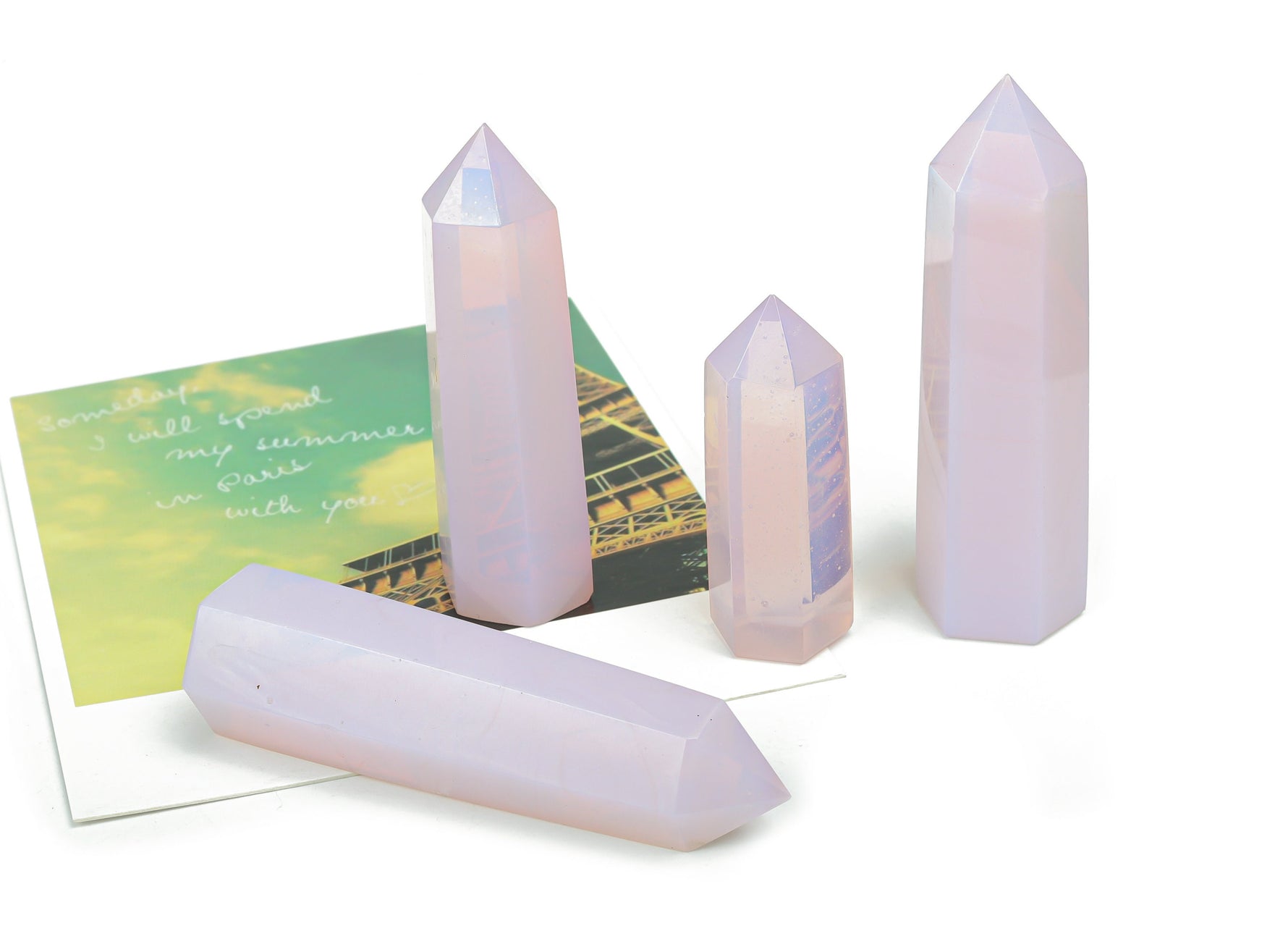 Pink opalite obelisk tower crystal from GemstoneGO, showcasing a smooth, polished pink gemstone obelisk with a pointed top.