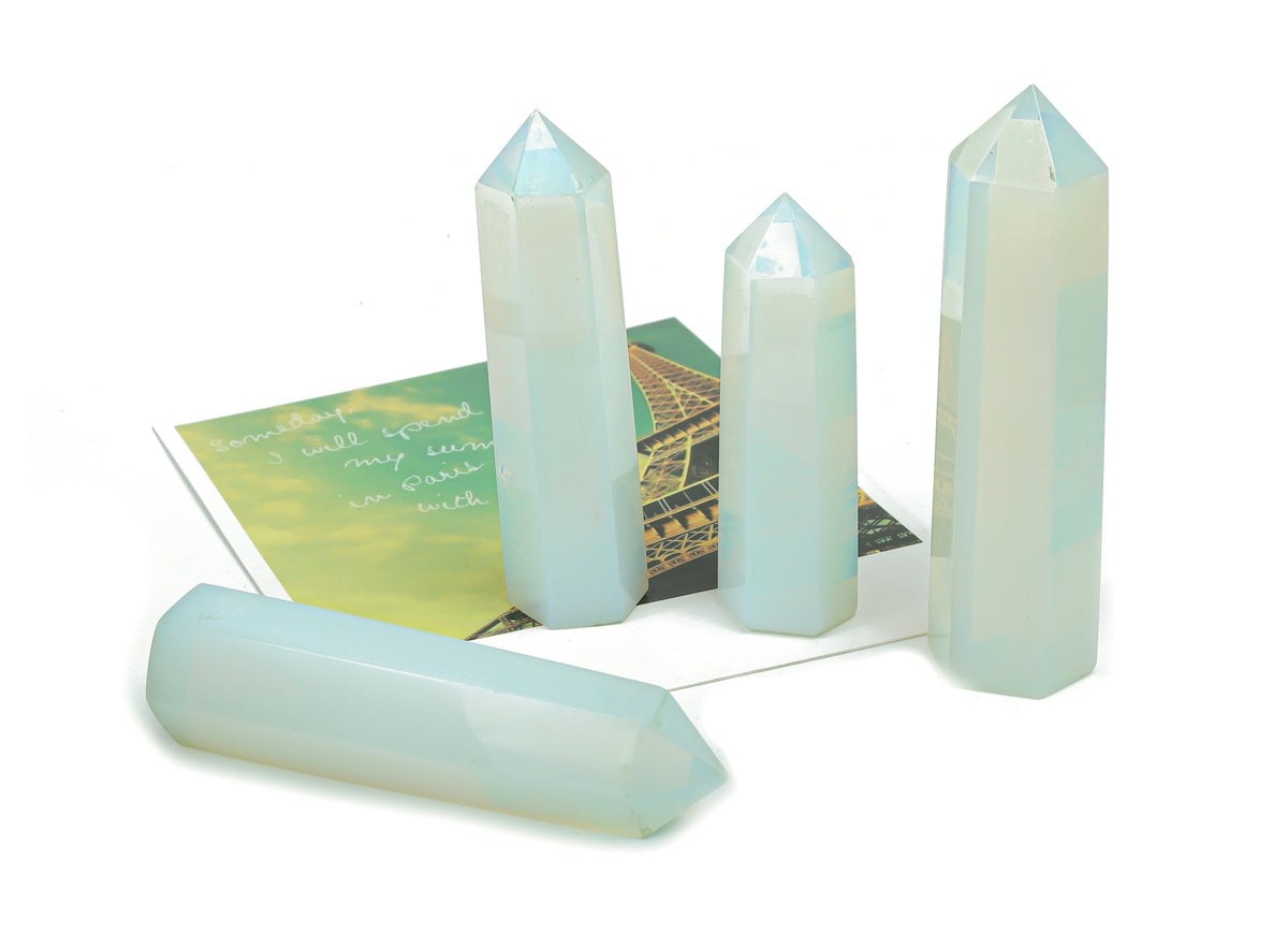 Opalite obelisk tower crystal by GemstoneGO, featuring a smooth, polished white and blue iridescent gemstone obelisk on a stand.