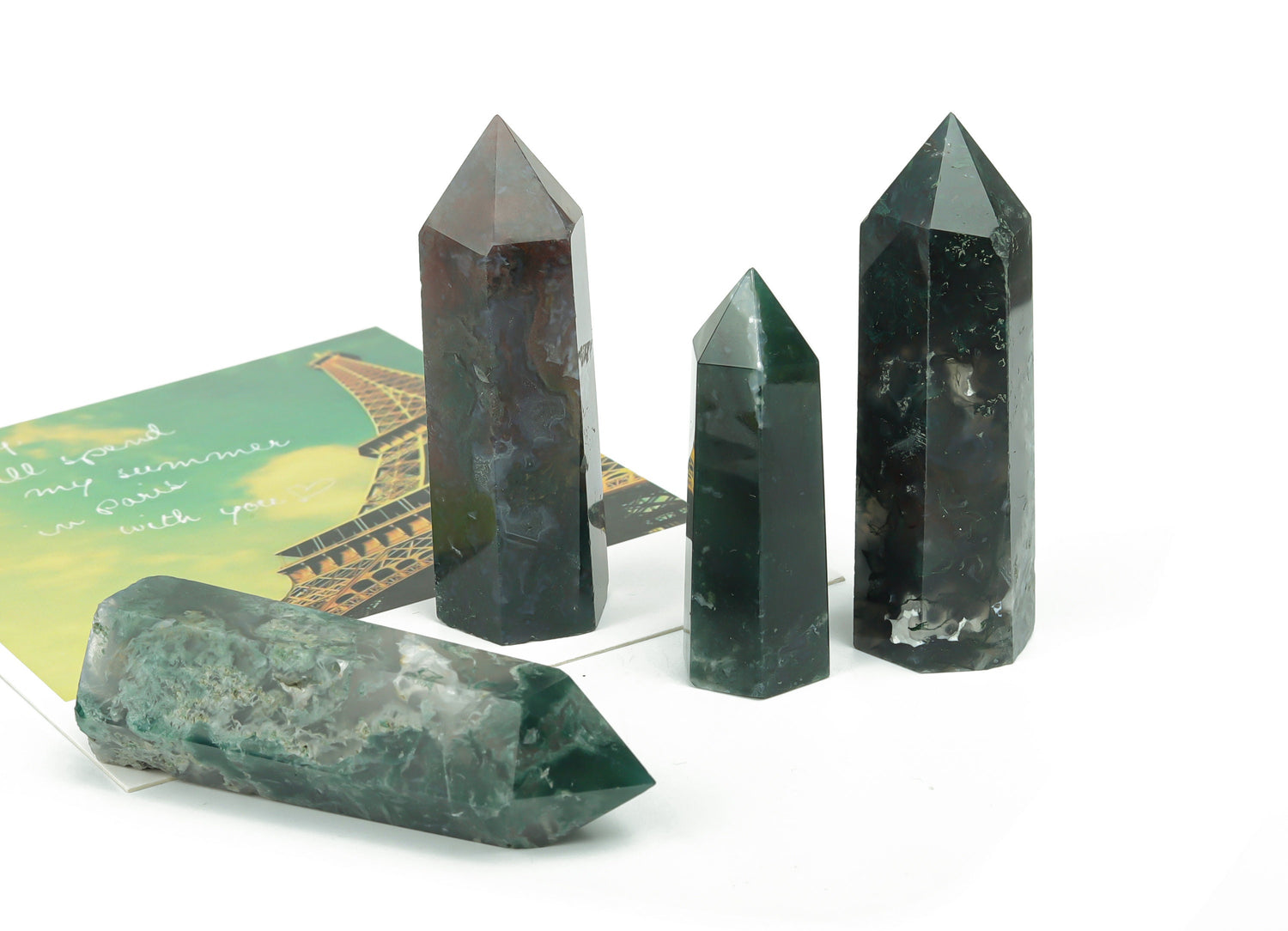 Moss agate obelisk tower crystal from GemstoneGO, showcasing green and brown mineral patterns on a polished surface.